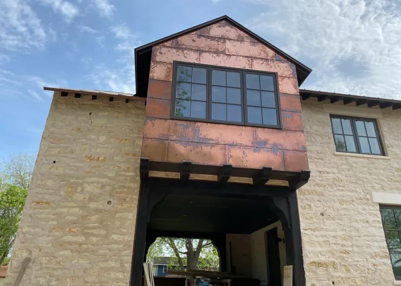 Copper metal panel facade on a stone building for Skylight Installation in Kaufman