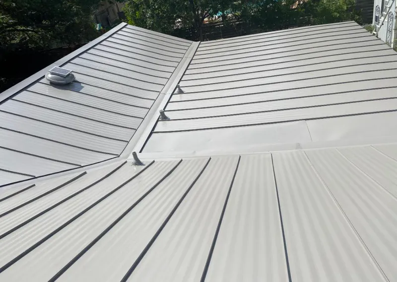 Solar attic fan installed on a metal roof for Roof Ventilation in Kaufman